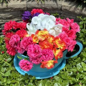 Giant blue tea cup full of flowers